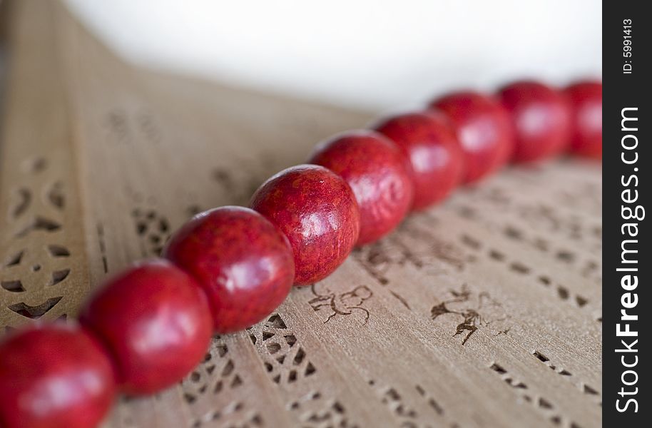 Red wooden beads with a fan. Red wooden beads with a fan