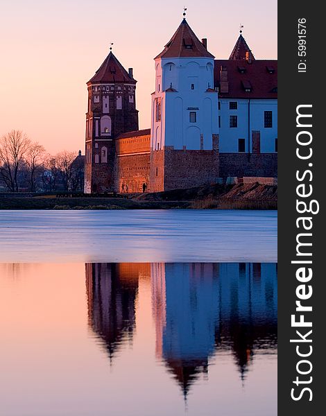 Old castle near lake in the evening