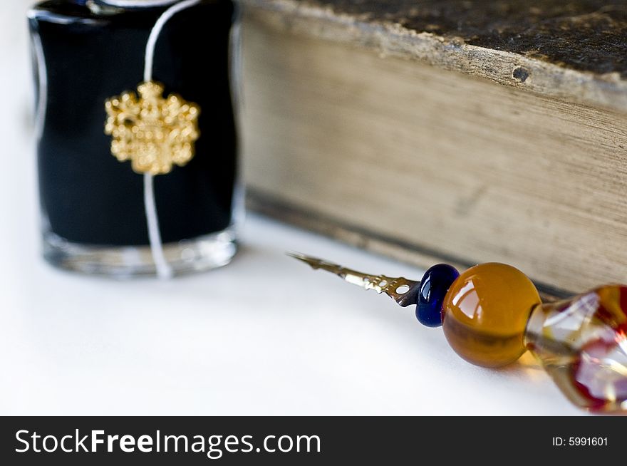 Ancient book with a feather and jar blackened on a white background. Ancient book with a feather and jar blackened on a white background