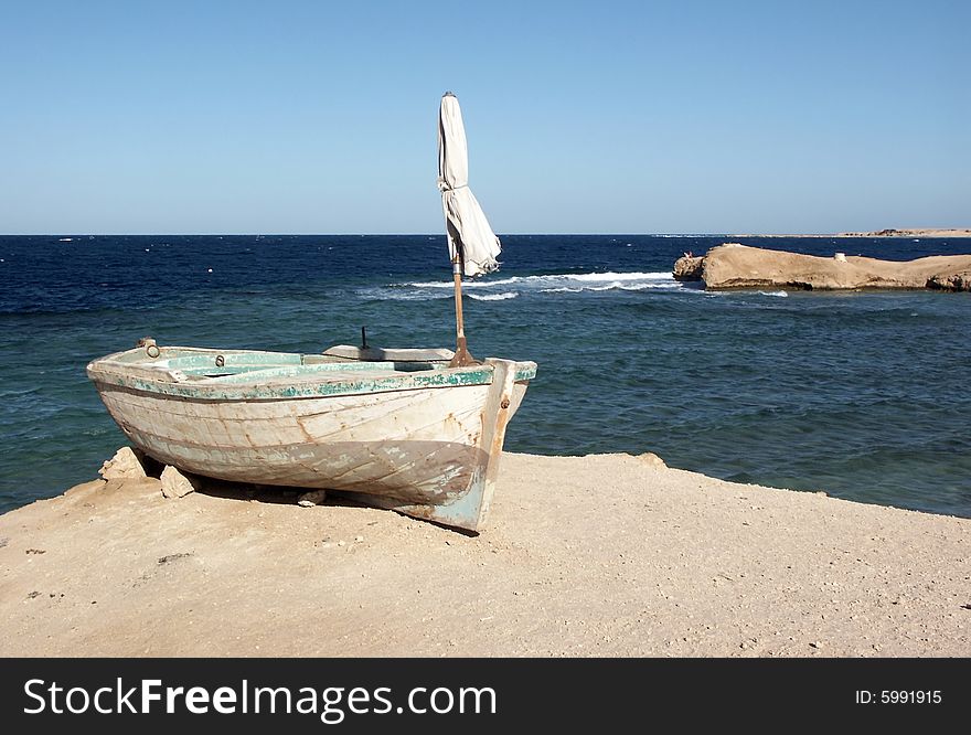 Old rowing boat on the sea-shore. Old rowing boat on the sea-shore