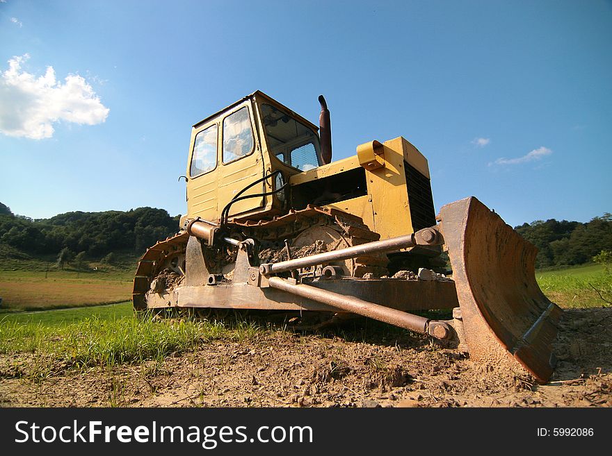 Photo of the yellow bulldozer on the timber line - Beskid mountains