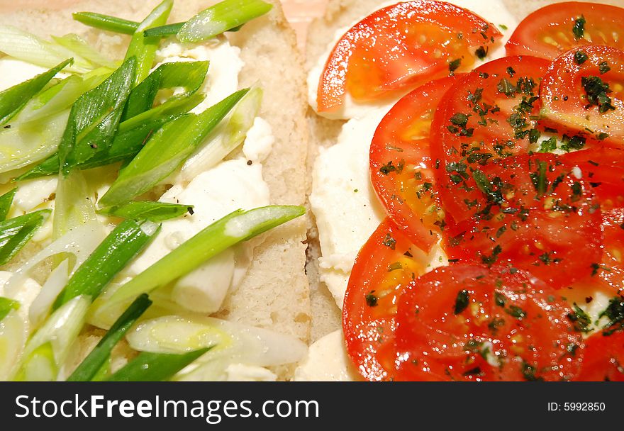 Slices of mozzarella, tomatoes and spring onion over freshly baked ciabatta. Slices of mozzarella, tomatoes and spring onion over freshly baked ciabatta.