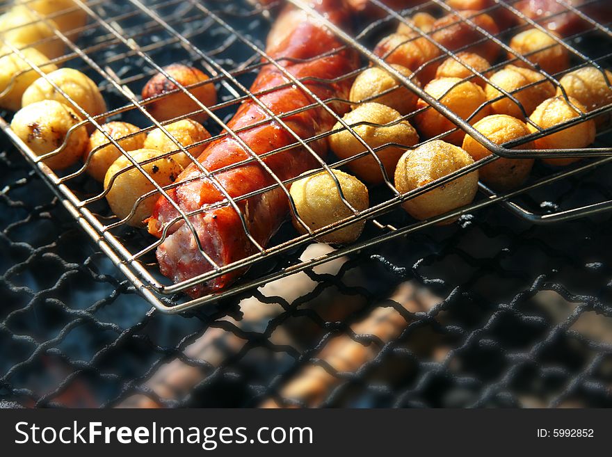 The photograph grilled of potatoes and the Polish sausage. The photograph grilled of potatoes and the Polish sausage
