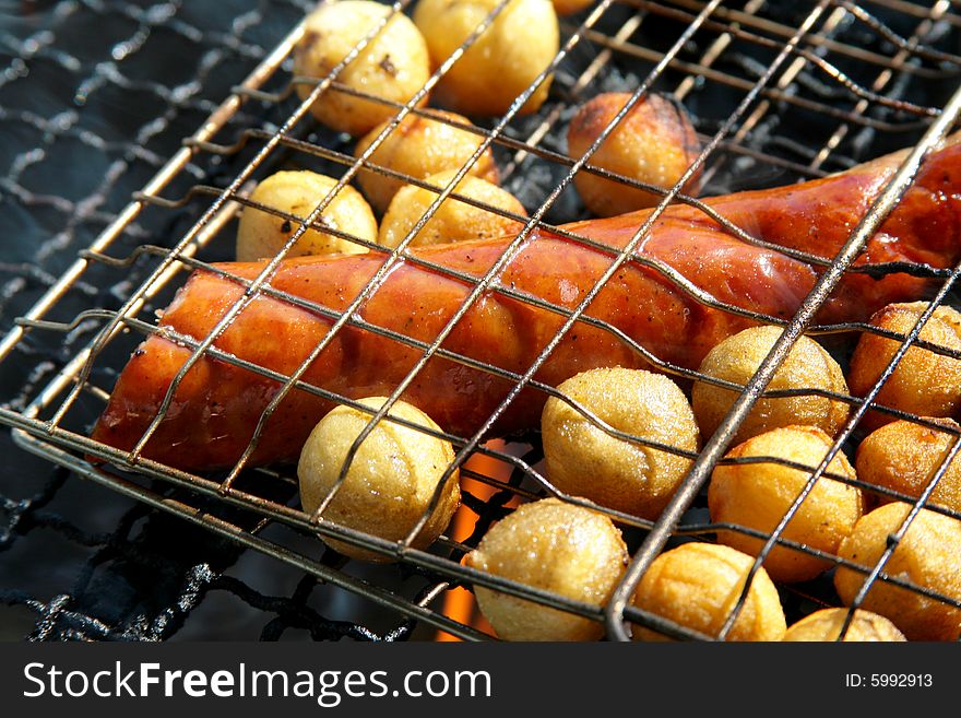 The photograph grilled of potatoes and the Polish sausage. The photograph grilled of potatoes and the Polish sausage