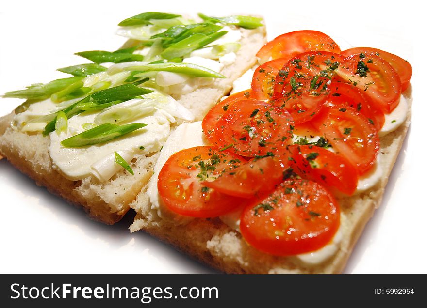 Slices of mozzarella, tomatoes and spring onion over freshly baked ciabatta. Slices of mozzarella, tomatoes and spring onion over freshly baked ciabatta.