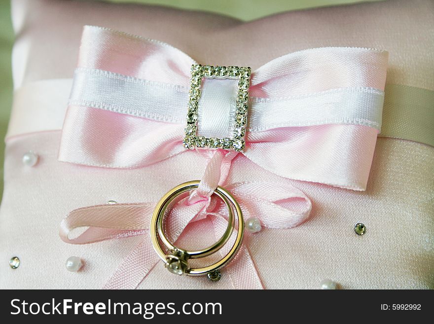 Wedding rings on the pink material