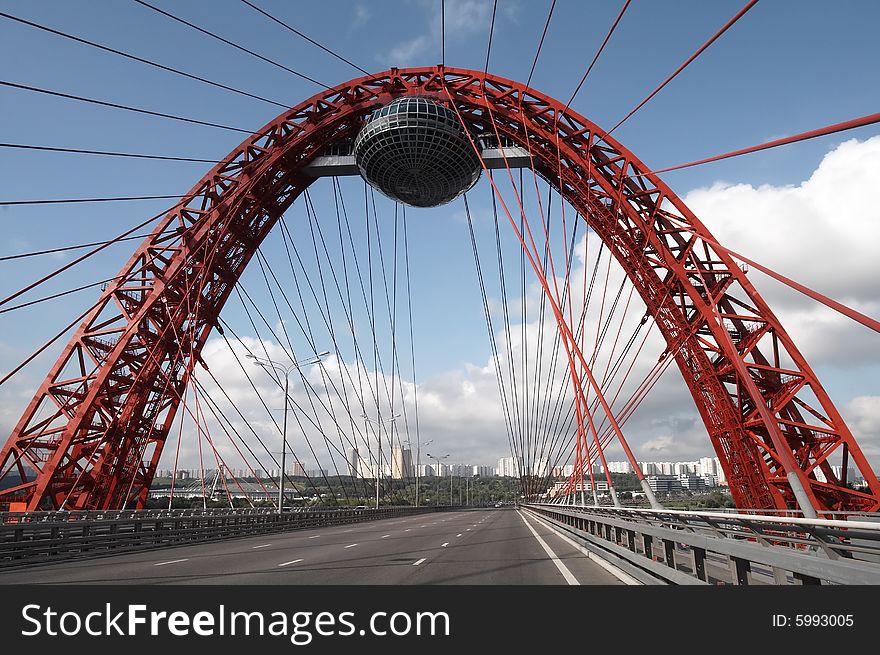 Modern bridge on cloudy sky