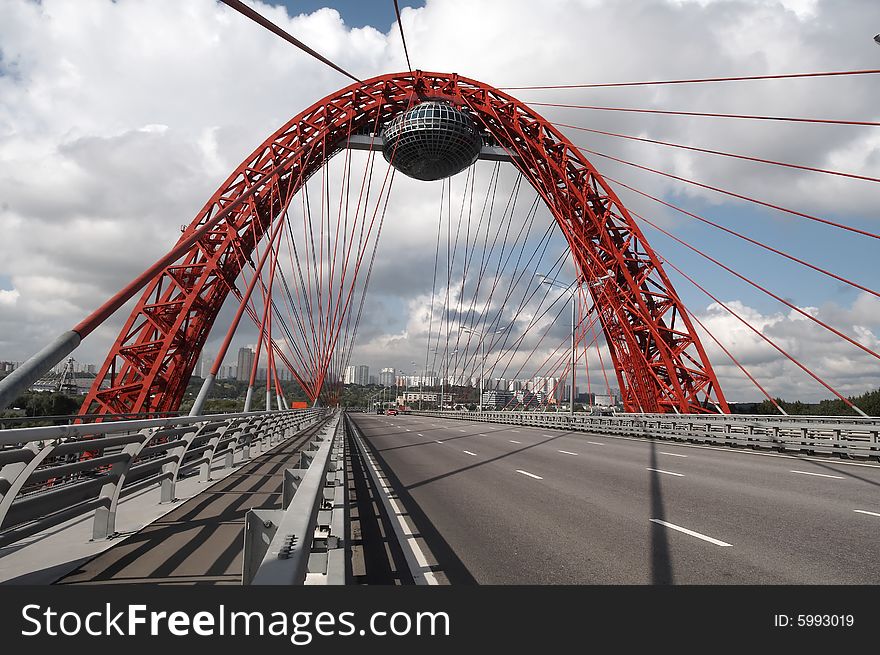 Modern bridge on blue sky with clouds