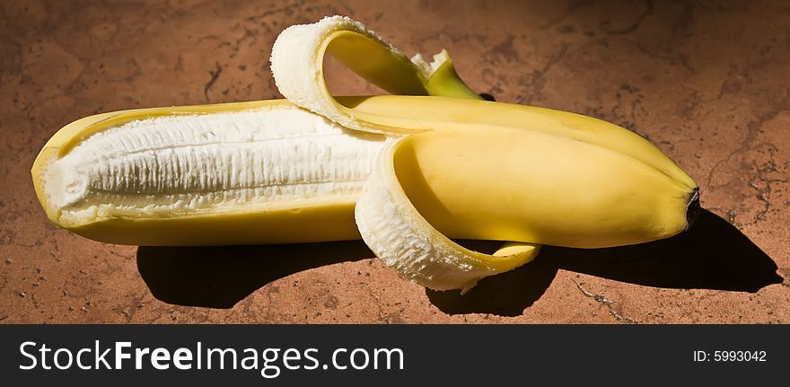 A single banana in the sun.