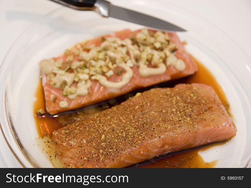 Two salmon fillets prepared with different sauces. Two salmon fillets prepared with different sauces