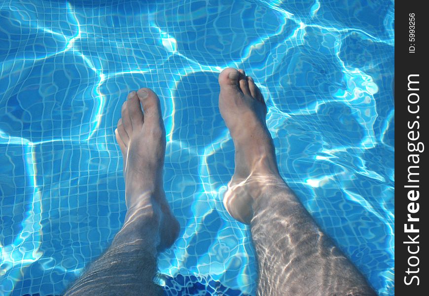 Man's Feet Underwater in Swimming Pool. Man's Feet Underwater in Swimming Pool