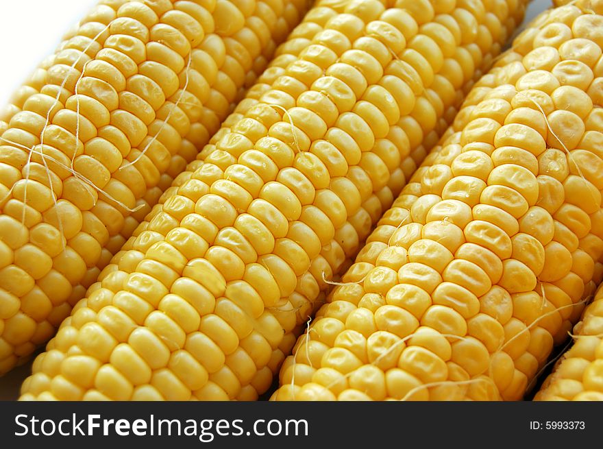 Ears of fresh corn as background