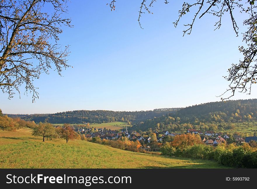 This image shows autumnal black forest with village
