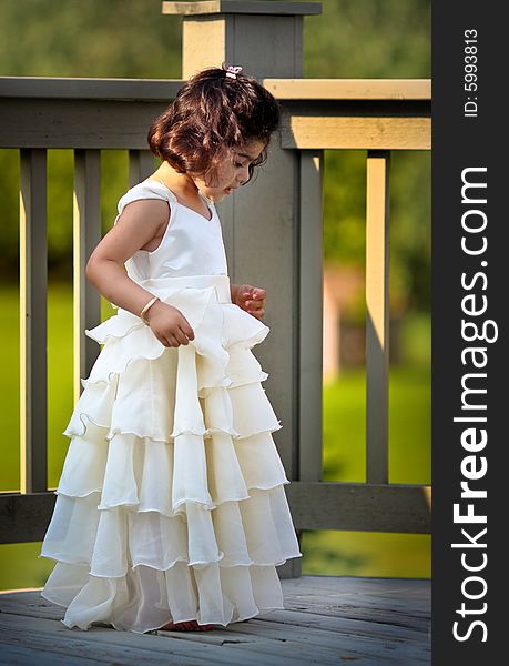 Shot of a two year old in a long white princess dress. Shot of a two year old in a long white princess dress.