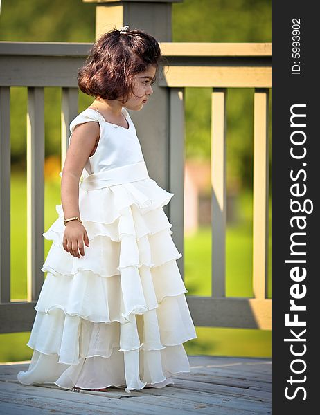 Shot of a two year old in a long white princess dress. Shot of a two year old in a long white princess dress.