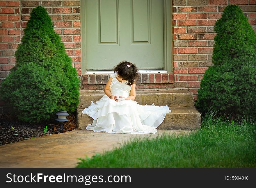 Shot of a two year old in a long white princess dress. Shot of a two year old in a long white princess dress.