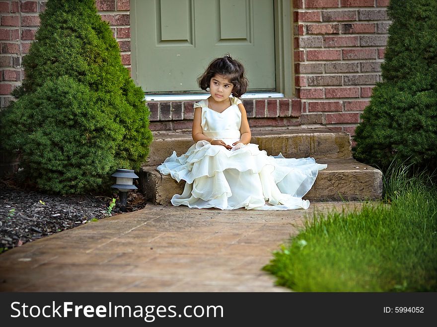 Shot of a two year old in a long white princess dress. Shot of a two year old in a long white princess dress.