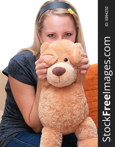 The girl with a teddy on the sofa. The girl with a teddy on the sofa