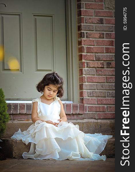 Shot of a two year old in a long white princess dress. Shot of a two year old in a long white princess dress.