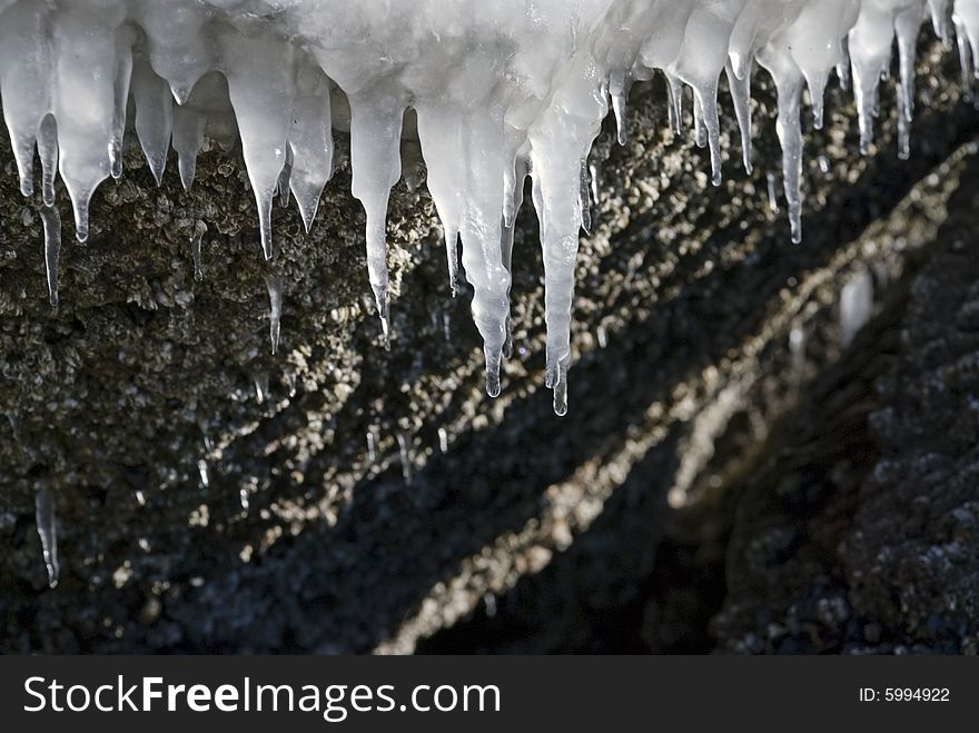 The winter goes near the end. Spring. Ice on stones. Melting icicles and snow. The winter goes near the end. Spring. Ice on stones. Melting icicles and snow