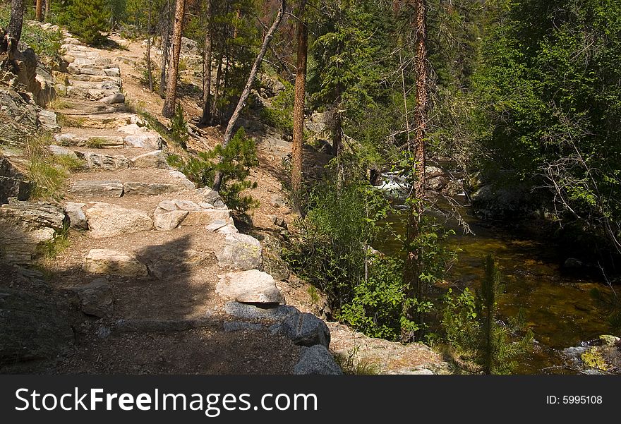 A rough hewn stair along a forest river in Rocky Mountain National Park. A rough hewn stair along a forest river in Rocky Mountain National Park