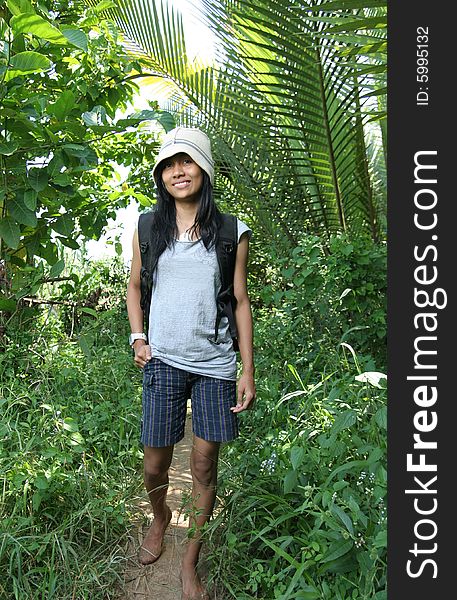 Photograph of backpacker girl wolking in nature