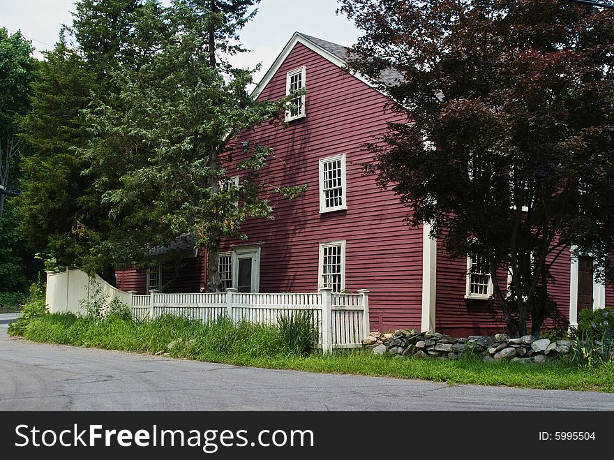 Old new england red and white house on a country road. Old new england red and white house on a country road