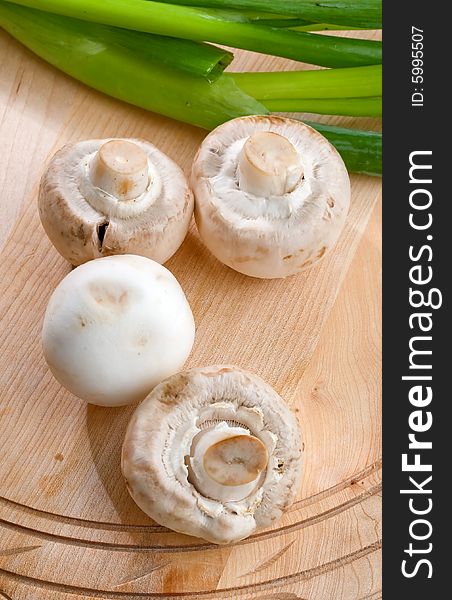 Fresh mushrooms with backlight and green onion