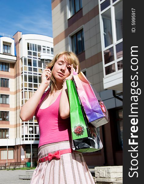 Tired girl with shopping bags outdoor