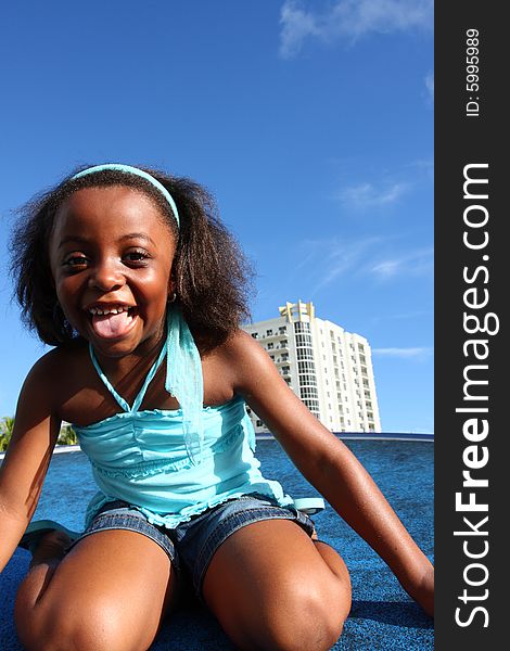 Young girl laughing with blue sky background which is usable as copyspace. Young girl laughing with blue sky background which is usable as copyspace.