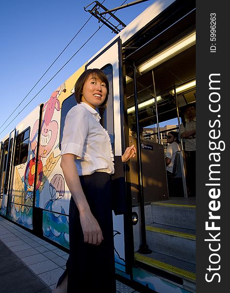 Smiling Woman Boards Train - Vertical