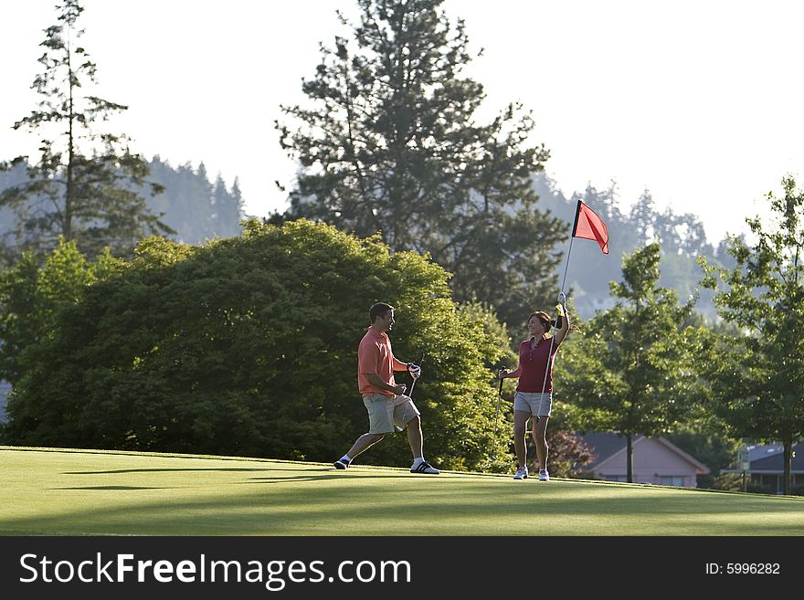 Man And Woman On Golf Course - Horizontal