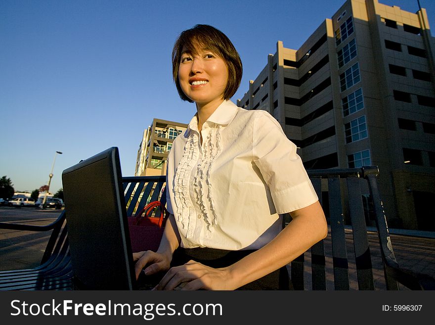 Smiling Woman Works On Laptop - Horizontal