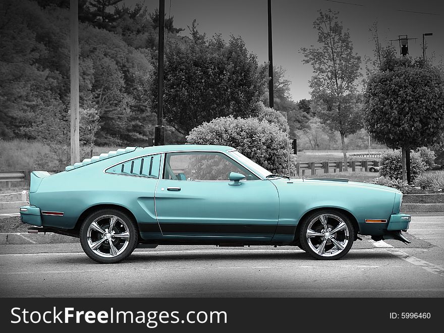 Blue-Green muscle car on the black and white background. Blue-Green muscle car on the black and white background