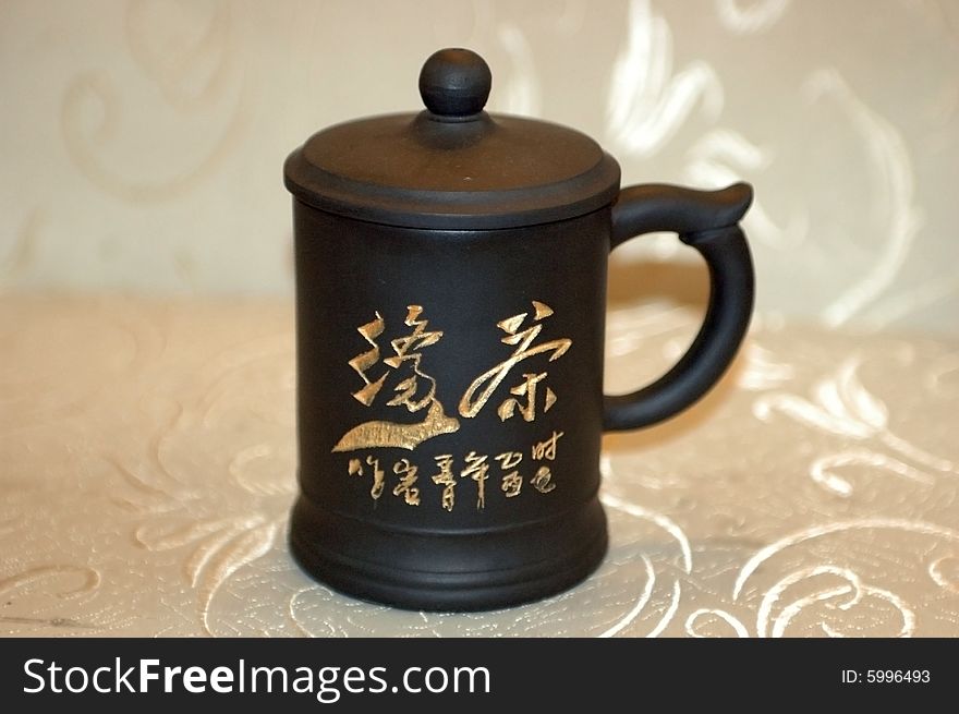 Traditional Chinese mug with special cover on top for brewing green tea. Traditional Chinese mug with special cover on top for brewing green tea.