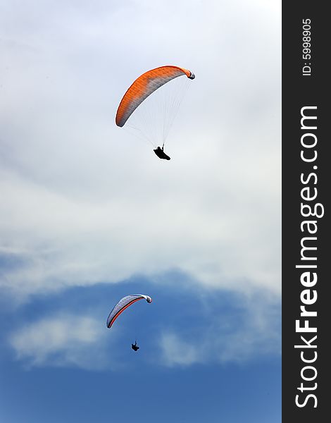 Two persons flying in blue sky. Two persons flying in blue sky