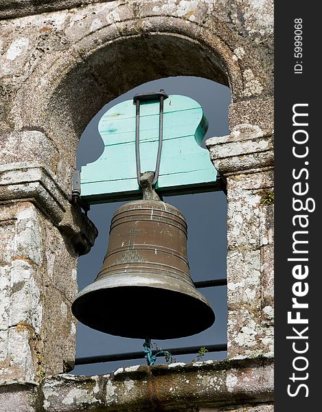 Close view of an ancient belfry with its bell. Close view of an ancient belfry with its bell