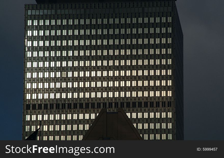 Skyscraper windows lit by early sun. Skyscraper windows lit by early sun