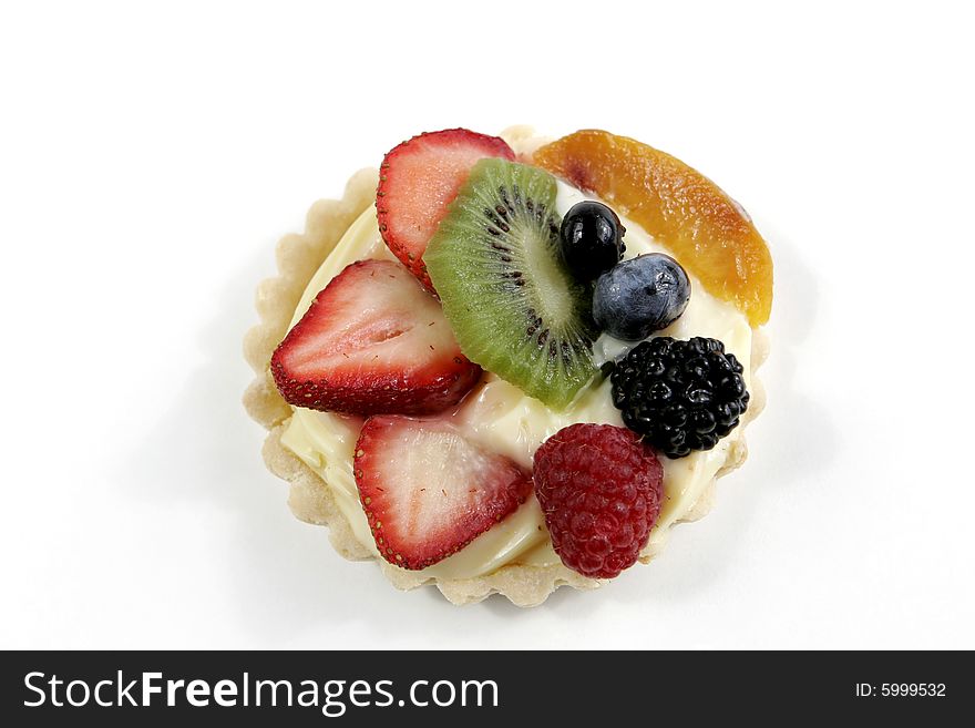 Cream-filled pastry tart topped with an assortment of juicy berries, kiwi, and peach. Cream-filled pastry tart topped with an assortment of juicy berries, kiwi, and peach.