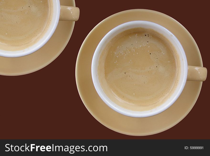 One and a half cup of coffee on a brown background