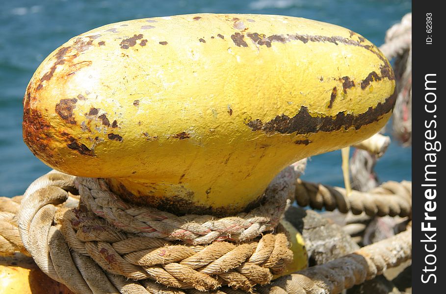 A nicely textured close up of a bollard on a wharf, showing the hawsers (ie, ropes)