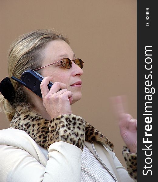 Woman talking on her cell phone. Left hand is blurred. Woman talking on her cell phone. Left hand is blurred