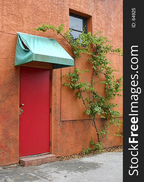 Red Door With Tattered Awning