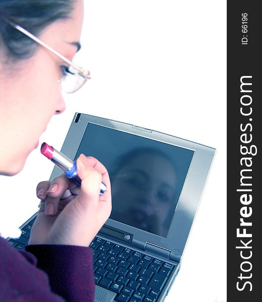 Woman using a lipstick in front of a laptop. Blue tone version. Woman using a lipstick in front of a laptop. Blue tone version.