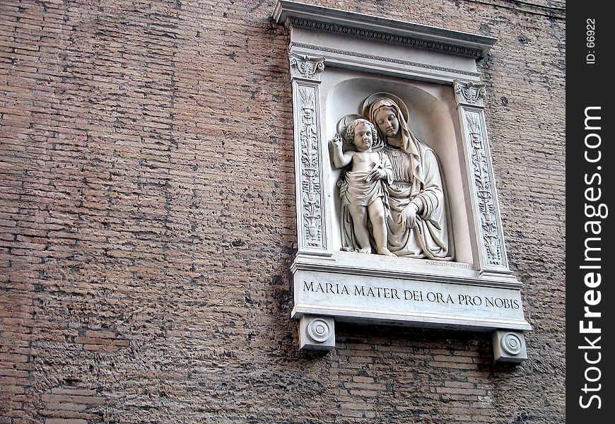 Statue of the Virgin and Jesus on a wall in Rome, Italy. Statue of the Virgin and Jesus on a wall in Rome, Italy