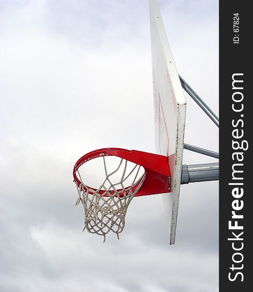 Basketball hoop against a cloudy sky