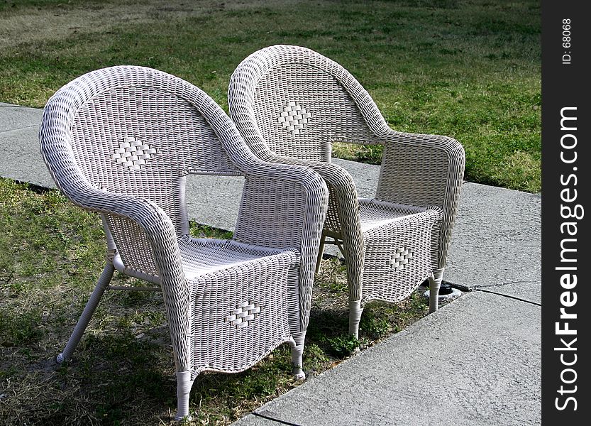 Two empty lawn chairs waiting for someone to occupy them