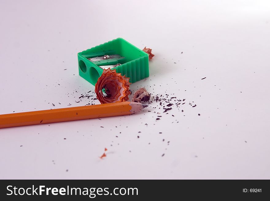 Pencil sharpener, pencil and debris. Pencil sharpener, pencil and debris.