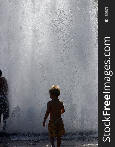 Kid playing in fountain.