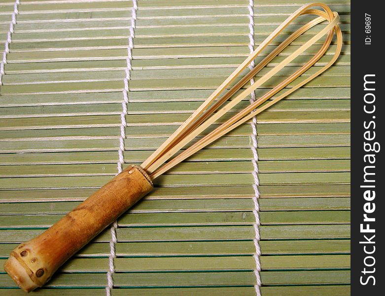 A useful tool for tea preparation during tea ceremony-bamboo whisk,on a bamboo floor. A useful tool for tea preparation during tea ceremony-bamboo whisk,on a bamboo floor